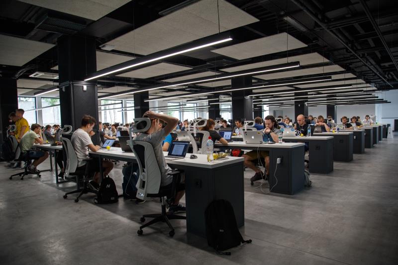 Modern call centre environment, rows of computer users.