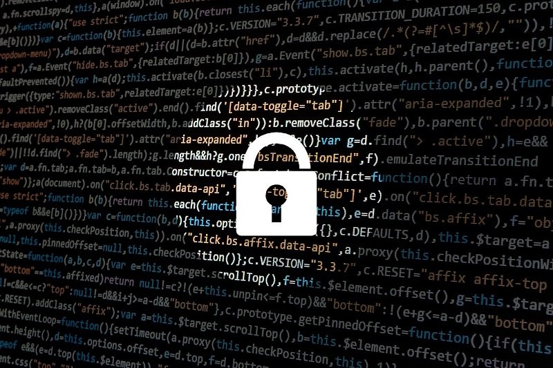 A backdrop of computer code with a superimposed padlock