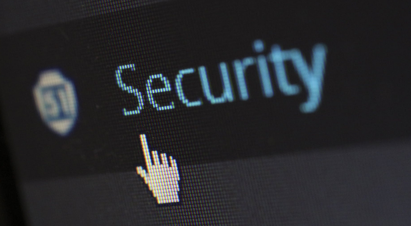 Image of computer display with hand pointer on the word "security"