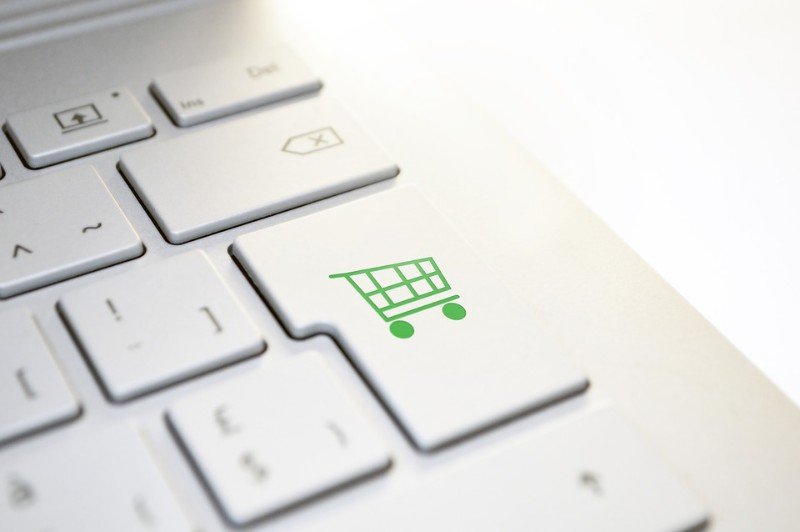 White laptop keyboard with shopping cart as the enter key