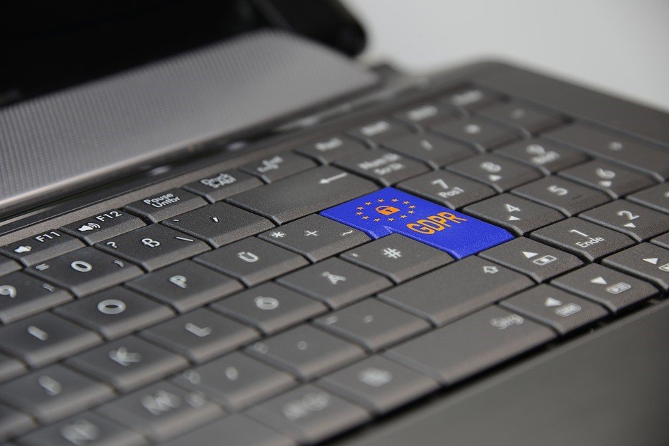 Laptop keyboard with a blue GDPR key in place of the enter key.