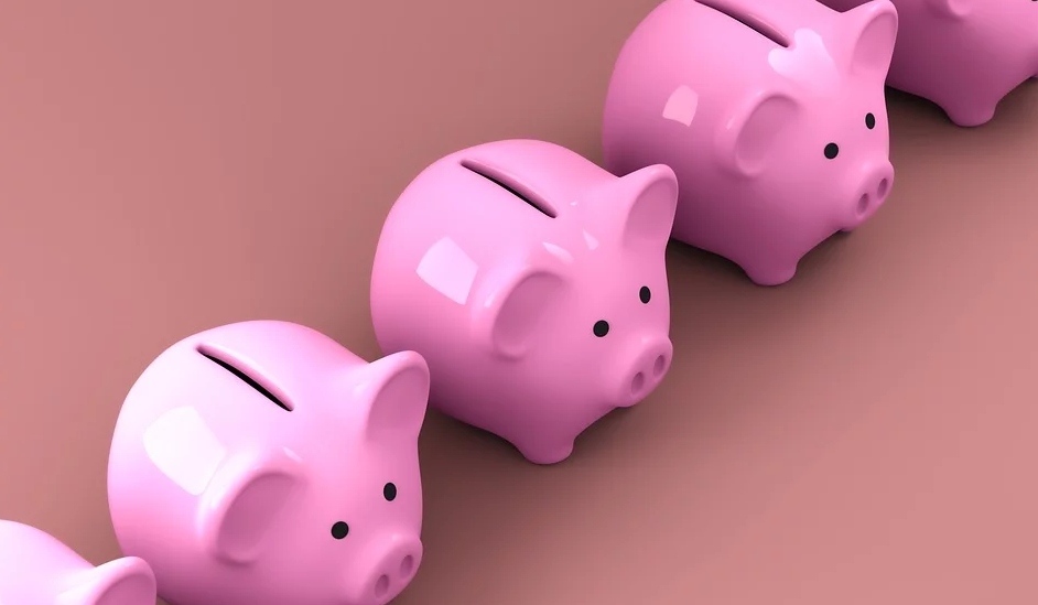 A row of shiny pink piggy banks